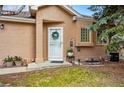 Inviting home entrance featuring a decorative wreath and well-manicured landscaping at 12610 E Wesley Pl, Aurora, CO 80014