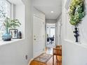 Bright hallway with hardwood floors and decorative accents at 12610 E Wesley Pl, Aurora, CO 80014