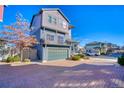 Contemporary two-story house with a two-car garage, complemented by a brick driveway and well-kept landscaping at 5295 Andes St, Denver, CO 80249