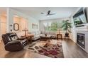 Spacious living room featuring a cozy fireplace, large windows, and comfortable seating at 1378 S Duquesne Ct, Aurora, CO 80018