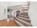 Carpeted staircase with wood and white trim leads to the upper level of the home at 5146 S Argonne St, Centennial, CO 80015