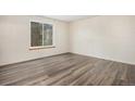 Comfortable bedroom with sleek flooring and a bright window offering natural light at 2750 S Rifle St, Aurora, CO 80013
