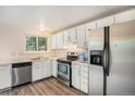 Functional kitchen featuring white cabinets, stainless steel appliances, and durable countertops at 2750 S Rifle St, Aurora, CO 80013