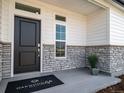 Inviting home exterior with stone accents and a modern front door at 5190 N Quemoy Ct, Aurora, CO 80019