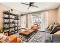 Inviting living room with modern decor, a stylish rug, comfortable seating, and a ceiling fan at 327 S Xanadu St, Aurora, CO 80012