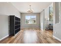 Open dining room featuring hardwood floors, a modern chandelier, and natural light at 3475 Golden Spur Loop, Castle Rock, CO 80108