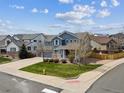 Beautiful two-story home with a three-car garage, front porch, and well-manicured lawn at 3475 Golden Spur Loop, Castle Rock, CO 80108