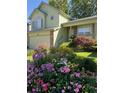 Two-story house with a landscaped front yard and flowerbeds at 3802 Desert Willow Ave, Broomfield, CO 80020