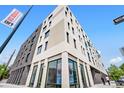 Modern multi-story apartment building featuring stylish brickwork and ample natural light from large windows at 603 Inca St # 530, Denver, CO 80204