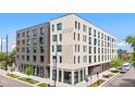 Modern multi-story apartment building featuring stylish brickwork and ample natural light from large windows at 603 Inca St # 530, Denver, CO 80204