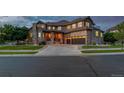 Charming two-story house featuring a stone facade, three-car garage, and well-maintained landscaping at 15501 Fairway Dr, Commerce City, CO 80022