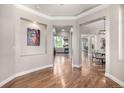 Elegant foyer with hardwood floors, decorative niches, and views into the living and dining areas at 15501 Fairway Dr, Commerce City, CO 80022