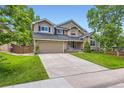 Beautifully landscaped home featuring a spacious driveway and a charming front yard at 9743 Chanteclair Cir, Highlands Ranch, CO 80126