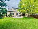 Well-maintained backyard with a circular patio and green lawn, perfect for outdoor relaxation at 21238 Snowshoe Ln, Parker, CO 80138