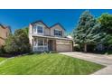 Charming two-story home featuring manicured lawn, a front porch, and attached two-car garage at 21238 Snowshoe Ln, Parker, CO 80138