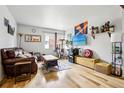 Bright living area with hardwood floors, comfortable seating, and entertainment setup at 3623 S Sheridan Blvd # 12, Denver, CO 80235
