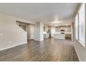 Open living area with hardwood floors and kitchen views at 18134 Prince Hill Cir, Parker, CO 80134