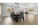 Elegant dining room with wood floors, a modern dining table, and lots of natural light at 9847 Helena Ct, Commerce City, CO 80022