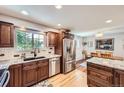 Well-lit kitchen with granite countertops, stainless steel appliances, and hardwood flooring at 10621 Julian St, Westminster, CO 80031