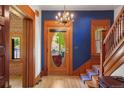Stunning foyer with a beautiful wood staircase and elegant chandelier at 2155 N High St, Denver, CO 80205