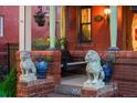 Charming front porch featuring classic lion statues and decorative floral arrangements at 2155 N High St, Denver, CO 80205