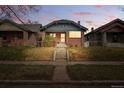 Charming brick home with a well-maintained front yard and a welcoming entrance at 618 Adams St, Denver, CO 80206