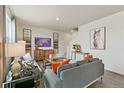 Spacious living room with gray sectional sofa and large TV at 6531 13Th St, Frederick, CO 80530