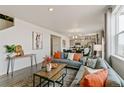 Living room features a gray sofa and a view into the kitchen at 6531 13Th St, Frederick, CO 80530