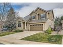 Charming home with a two car garage, a lush lawn, and mature landscaping at 6172 S Salida Ct, Aurora, CO 80016
