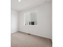 Bright bedroom with neutral carpet, a double window, and fresh white walls at 45946 Gentry Ave, Bennett, CO 80102