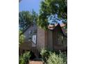 Exterior view of the house highlighting architectural details like the chimney and the elevated deck at 17336 E Rice Cir # F, Aurora, CO 80015