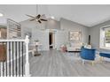 Bright living room featuring vaulted ceilings, modern flooring, and barn door with a seating area at 17336 E Rice Cir # F, Aurora, CO 80015