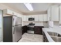 Modern kitchen with stainless steel appliances and white cabinets at 384 S Decatur St, Denver, CO 80219