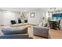 Bright and spacious living room with hardwood floors, neutral decor, and an open layout perfect for gatherings at 15034 E Floyd Ave, Aurora, CO 80014