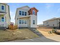 Stylish two-story house with covered porch, modern color scheme, and low maintenance yard at 5928 N Lisbon St, Aurora, CO 80019