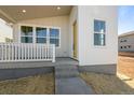 Inviting front porch with a modern color scheme and a striking yellow door, and new yard at 5928 N Lisbon St, Aurora, CO 80019