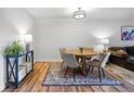 Cozy dining area featuring a round table, four chairs, and a colorful rug over hardwood floors at 888 N Logan St # 5A, Denver, CO 80203