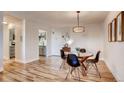 Inviting dining area with hardwood floors, a round table with chairs, and an open flow to the kitchen at 888 N Logan St # 5A, Denver, CO 80203