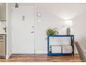 Hallway with neutral walls, hardwood floors, and a blue console table with decor at 888 N Logan St # 5A, Denver, CO 80203