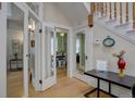This home features a bright foyer with wooden floors, a staircase and glass paned doors at 1315 Gaylord St, Denver, CO 80206
