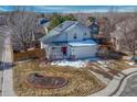 Charming two-story home with solar panels, well-maintained lawn, and attached two-car garage at 12521 S Elk Creek Way, Parker, CO 80134