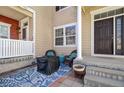 Inviting front porch with seating, a stylish rug, and a charming exterior view creating a cozy outdoor space at 1496 Red Cliff Way, Castle Rock, CO 80109