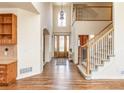 Grand foyer featuring a soaring ceiling, hardwood floors, and an elegant staircase at 6271 S Billings Way, Centennial, CO 80111