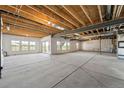 Unfinished basement with exposed wooden beams, concrete floor and multiple windows allowing natural light at 3327 Backdrop Ct, Castle Rock, CO 80108