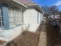 Exterior side view of the house showing the siding and access to backyard at 410 Baker St, Longmont, CO 80501