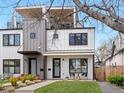 Modern two-story home showcasing clean lines, a rooftop deck, and manicured front lawn at 4525 N Raleigh St, Denver, CO 80212