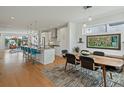 Bright and airy open floor plan featuring a modern kitchen with breakfast bar, dining table, and relaxing living area at 4525 N Raleigh St, Denver, CO 80212