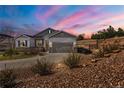 Beautiful home exterior at sunset with a well-maintained yard, rock landscaping, and inviting curb appeal at 3309 Thornwood Ct, Castle Rock, CO 80108
