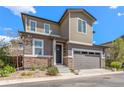 Inviting two-story home featuring a stone facade, neutral siding, and attached two-car garage at 11235 S Neu Towne Cir, Parker, CO 80134