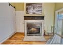 Brick fireplace with black trim detail with an adjacent storage cabinet at 4771 White Rock Cir # C, Boulder, CO 80301